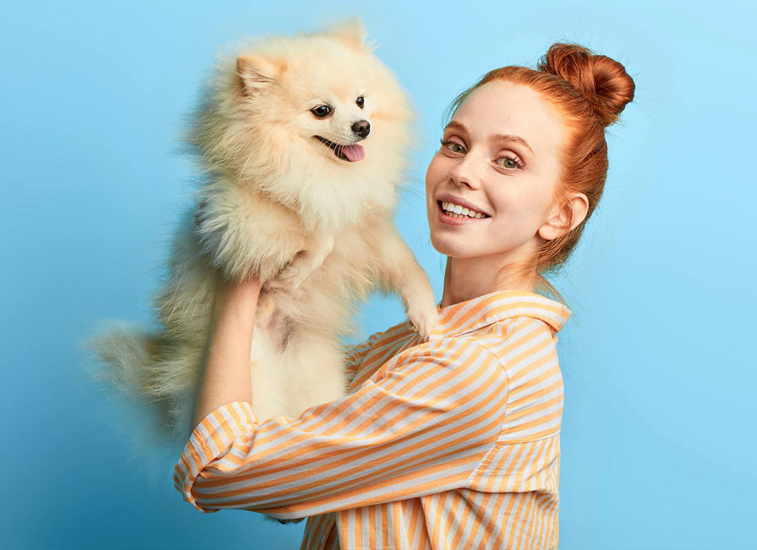 lady holding Pomeranian dog